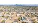 Aerial view of expansive desert property with mountain views and residential neighborhood at 9120 E Dennis St, Mesa, AZ 85207