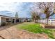 Expansive backyard with grass, trees, brick border and covered patio at 9120 E Dennis St, Mesa, AZ 85207