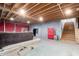 Spacious unfinished basement showcasing exposed ceiling beams, concrete walls, and wooden staircase at 9120 E Dennis St, Mesa, AZ 85207