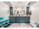 Bright bathroom featuring dual sinks, painted cabinets, framed mirrors, sconce lighting, and tile flooring at 9120 E Dennis St, Mesa, AZ 85207