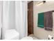 Tiled shower in bathroom with updated lighting and toilet at 9120 E Dennis St, Mesa, AZ 85207