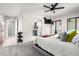 Spacious primary bedroom showcasing a ceiling fan, mounted television, and arched doorway to en suite bathroom at 9120 E Dennis St, Mesa, AZ 85207