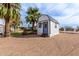 Exterior view of white building with black trim and a gravel yard at 9120 E Dennis St, Mesa, AZ 85207
