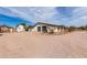 Side view of a white house with a gray garage and a separate white storage building at 9120 E Dennis St, Mesa, AZ 85207