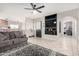 Inviting living room featuring a plush gray sofa, custom built-ins, and stylish decor at 9120 E Dennis St, Mesa, AZ 85207