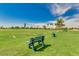 Scenic view of the golf course featuring lush green grass, mature trees and seating at 9338 E Cherrywood Dr, Sun Lakes, AZ 85248