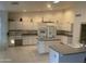 Spacious kitchen with island, white cabinets, and granite countertops at 9338 E Cherrywood Dr, Sun Lakes, AZ 85248