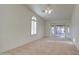 Well lit living room featuring carpet, a ceiling fan, and sliding glass doors at 9338 E Cherrywood Dr, Sun Lakes, AZ 85248