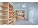 Built-in shelving and ceiling fan in this home office at 9338 E Cherrywood Dr, Sun Lakes, AZ 85248