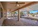 Covered patio with brick floors and ceiling fans overlooking the landscaped backyard at 9338 E Cherrywood Dr, Sun Lakes, AZ 85248