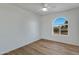 Bright bedroom with wood floors and arched window at 10001 N 87Th Ln, Peoria, AZ 85345