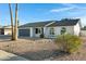 Updated single story home with rock landscaping and a gray garage door at 10001 N 87Th Ln, Peoria, AZ 85345