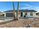 White single story home with gray roof and dark gray garage door at 10001 N 87Th Ln, Peoria, AZ 85345