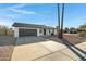 House exterior, showcasing a gray garage door and a palm tree at 10001 N 87Th Ln, Peoria, AZ 85345