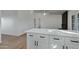 White kitchen island with quartz countertop and black hardware at 10001 N 87Th Ln, Peoria, AZ 85345