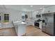 Modern kitchen with white cabinets, stainless steel appliances, and a large island at 10001 N 87Th Ln, Peoria, AZ 85345