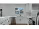 Modern kitchen features white shaker cabinets, quartz countertops, and stainless steel appliances at 10001 N 87Th Ln, Peoria, AZ 85345