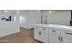 White kitchen island with quartz countertop and black hardware at 10001 N 87Th Ln, Peoria, AZ 85345