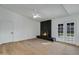 Living room with fireplace, wood floors and sliding glass doors at 10001 N 87Th Ln, Peoria, AZ 85345