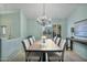 Bright dining room with a rustic wooden table and chandelier at 10048 E Emerald Dr, Sun Lakes, AZ 85248