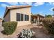 Desert landscaping with patio cover and cactus plants at 10605 E Nacoma Dr, Sun Lakes, AZ 85248