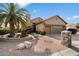 Single-story home with a two-car garage and desert landscaping at 10605 E Nacoma Dr, Sun Lakes, AZ 85248