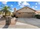 Single-story home with a two-car garage and palm tree at 10605 E Nacoma Dr, Sun Lakes, AZ 85248