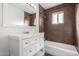 Clean bathroom with white vanity, brown tile, and bathtub at 1061 W 5Th St, Mesa, AZ 85201