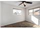 Bright bedroom with two windows, ceiling fan, and carpet at 1061 W 5Th St, Mesa, AZ 85201