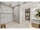 Modern bathroom with large shower, herringbone tile, and walk-in closet access at 10639 E Fernwood Ln, Scottsdale, AZ 85262