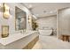 Spa-like bathroom with freestanding tub, large vanity, and modern fixtures at 10639 E Fernwood Ln, Scottsdale, AZ 85262