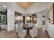 Elegant dining room with a wood table, and large windows showcasing scenic views at 10639 E Fernwood Ln, Scottsdale, AZ 85262