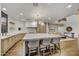 Modern kitchen features a large island with seating, light wood cabinetry, and breakfast bar at 10639 E Fernwood Ln, Scottsdale, AZ 85262