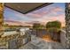 Outdoor kitchen with built-in grill and stone countertops at 10639 E Fernwood Ln, Scottsdale, AZ 85262