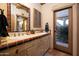 Bathroom with double vanity, terracotta tile and private access to the exterior at 26325 N 107Th Way, Scottsdale, AZ 85255