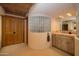 Spa-like bathroom with glass block feature wall, wooden vanity, and ample storage at 26325 N 107Th Way, Scottsdale, AZ 85255