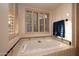 Relaxing bathroom with soaking tub and plantation shutters at 26325 N 107Th Way, Scottsdale, AZ 85255