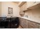 Laundry room with washer, dryer, and wooden cabinets at 26325 N 107Th Way, Scottsdale, AZ 85255