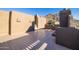 Sun-drenched patio with stucco walls and a built-in fireplace at 26325 N 107Th Way, Scottsdale, AZ 85255