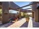 Spacious outdoor patio with terracotta tile flooring, wooden beams, and potted plants at 26325 N 107Th Way, Scottsdale, AZ 85255