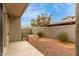 Small backyard with gravel, small tree, and patio at 1094 S 151St S Ln, Goodyear, AZ 85338