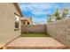 Small grassy backyard with brick patio and block wall at 1094 S 151St S Ln, Goodyear, AZ 85338