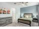 Bright bedroom featuring a ceiling fan and large dresser at 1094 S 151St S Ln, Goodyear, AZ 85338