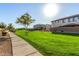 Well-manicured common green space with a tree and sidewalks on a beautiful sunny day at 1094 S 151St S Ln, Goodyear, AZ 85338