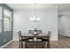 Dining area with gray walls, wood floors, and a four-person table at 1094 S 151St S Ln, Goodyear, AZ 85338