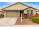 One-story house with light beige exterior, two-car garage, and landscaping at 1094 S 151St S Ln, Goodyear, AZ 85338