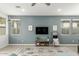 Living area with gray walls, wood floors, and a mounted TV at 1094 S 151St S Ln, Goodyear, AZ 85338