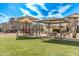 Community picnic area with covered seating and a nearby playground on a sunny day at 1094 S 151St S Ln, Goodyear, AZ 85338