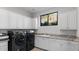 Bright laundry room with modern appliances and granite counters at 11510 E Mirasol Cir, Scottsdale, AZ 85255