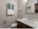 Cozy bathroom featuring a modern vanity, toilet, and a towel rack with fresh, clean towels at 1219 E Seldon Ln, Phoenix, AZ 85020